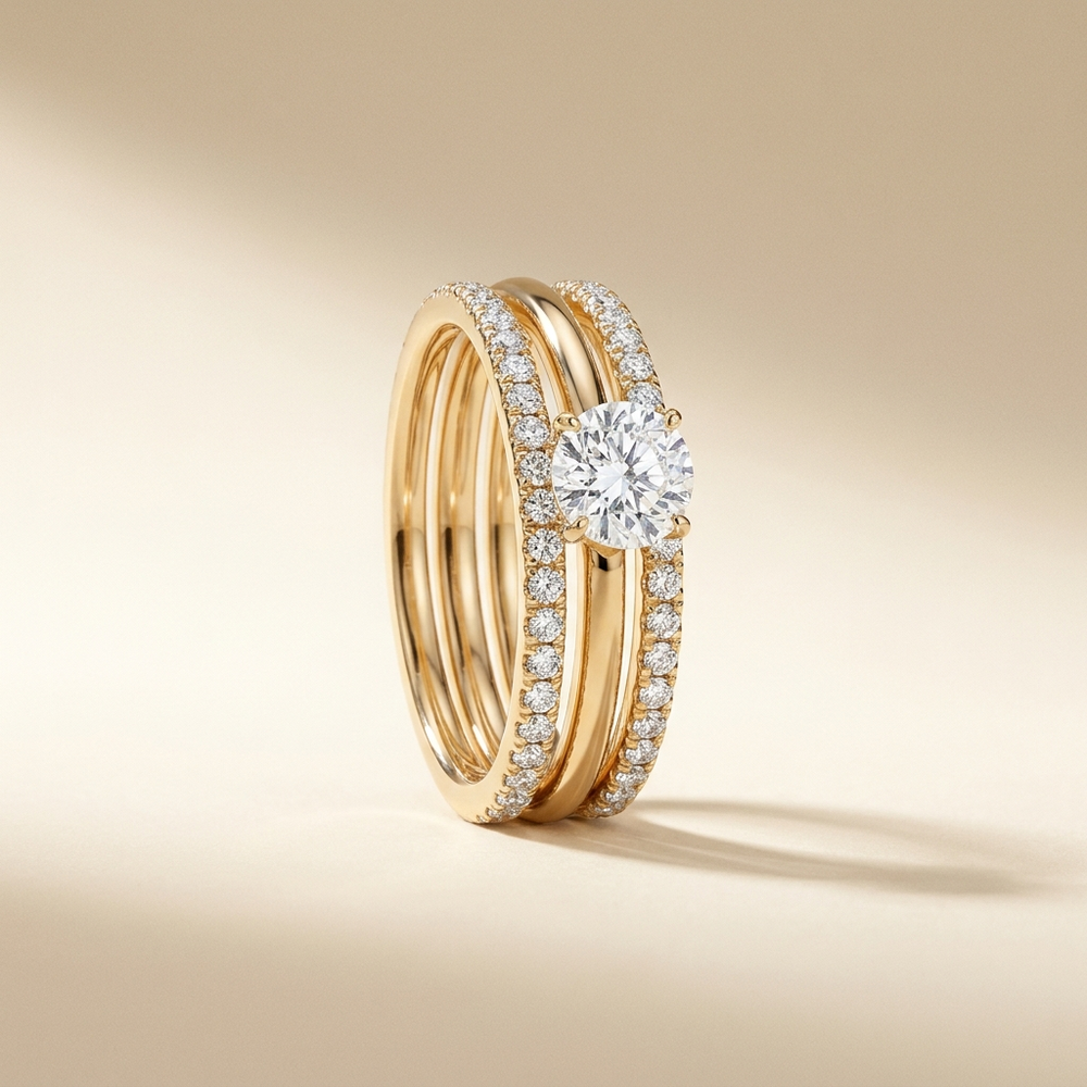 Célestine Radiance Stacked Ring — gold-tone triple-band ring with pavé detailing and a raised brilliant-cut centre stone
