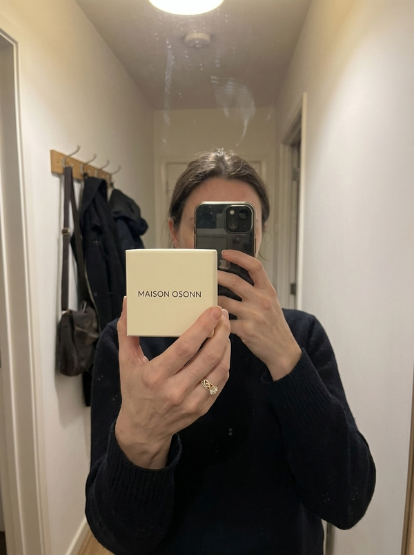 Maison Osonn Héritage Sculpted Ring held with its box in a mirror photo