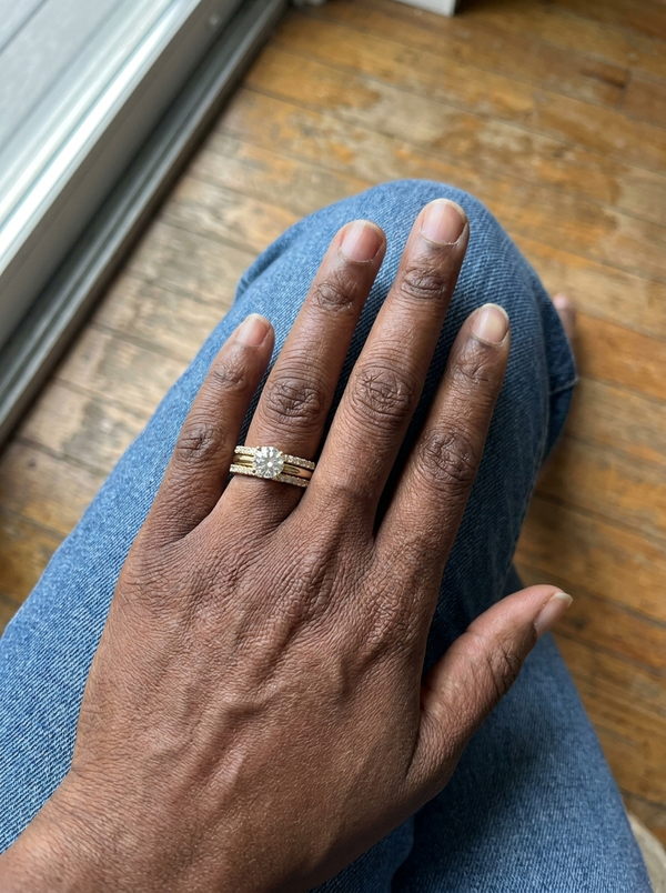 Maison Osonn Célestine Radiance Stacked Ring worn on a hand resting on a knee