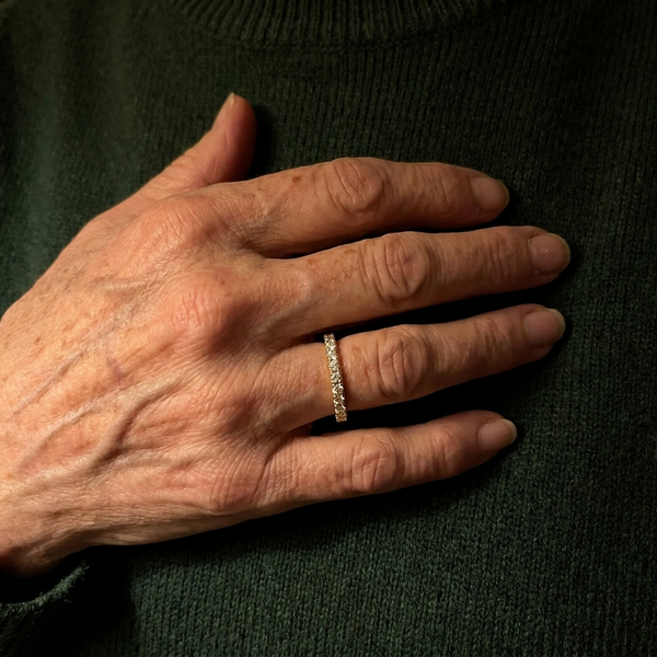 Maison Osonn Aurélie Signature Pavé Ring on a hand against a knitted jumper